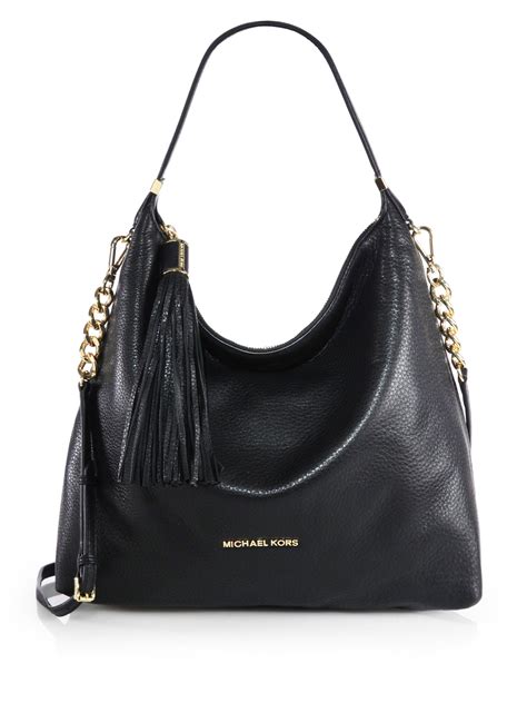 do any michael kors bags have black lining|Michael Kors black leather handbag.